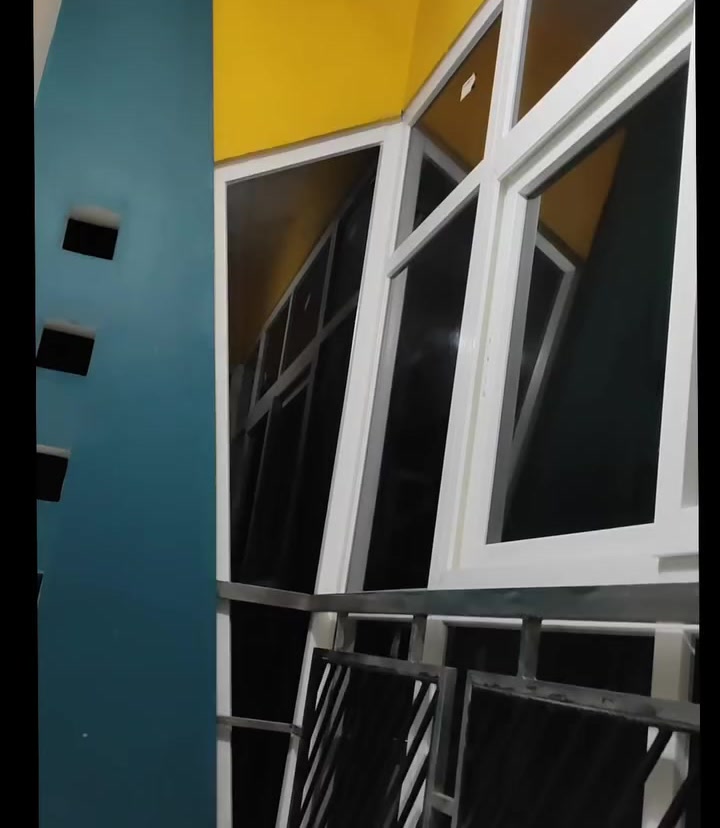 Installed UPVC multi-pane glass window frames on angled villa opening