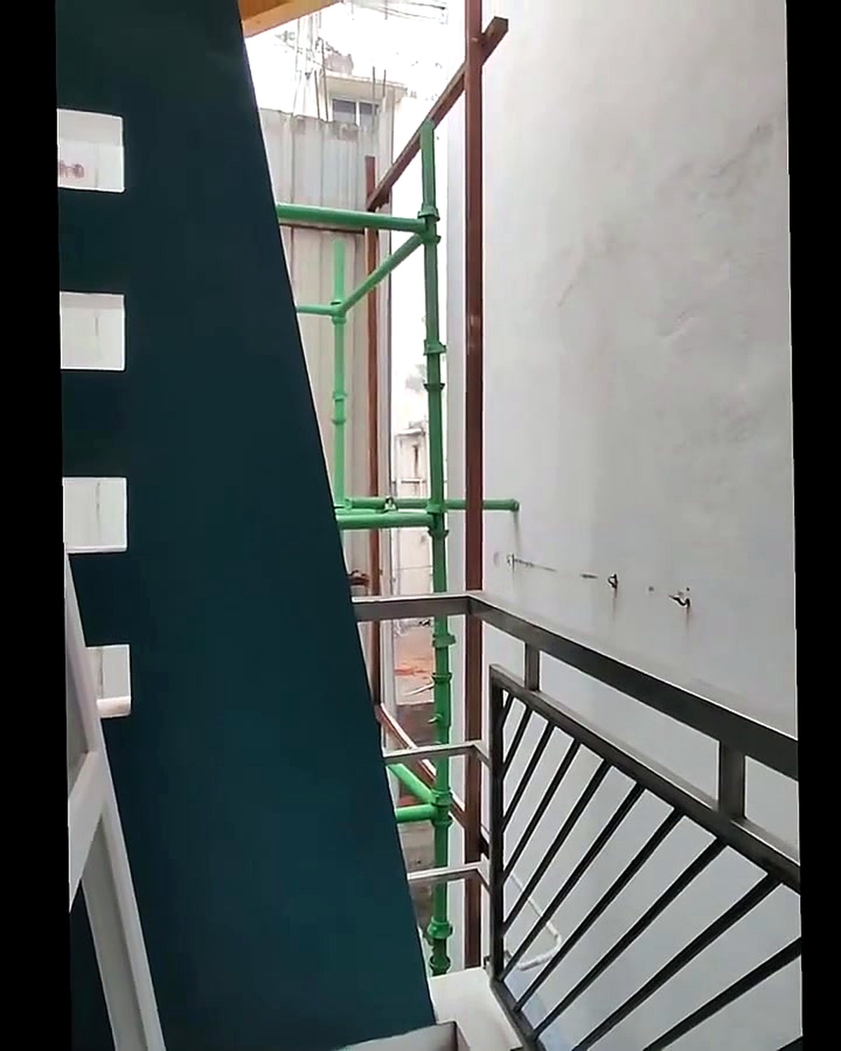 Before UPVC installation showing scaffolding and framing on angled balcony opening prior to window fitting